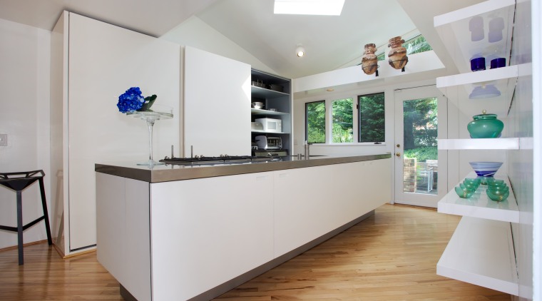Appliances are concealed in this minimalist galley kitchen interior design, kitchen, real estate, gray