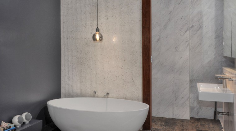A mosaic blade wall hides the toilet and bathroom, bathroom sink, bidet, ceramic, floor, flooring, interior design, plumbing fixture, product design, room, sink, tap, tile, wall, gray