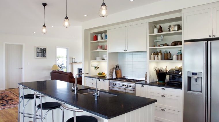 This traditionally styled kitchen, designed and manufactured by countertop, floor, flooring, hardwood, interior design, kitchen, room, wood flooring, gray