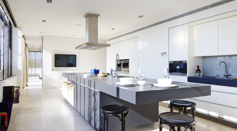 A cantilevered end to this 4.6m-long island forms countertop, interior design, kitchen, room, white