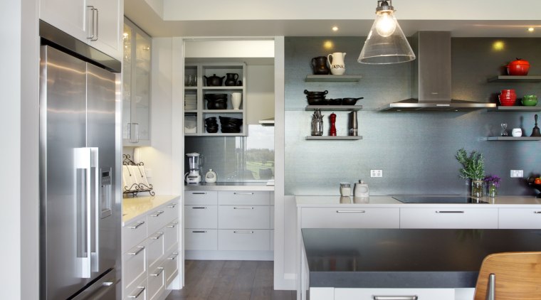 The open door to the scullery shows that cabinetry, countertop, cuisine classique, floor, flooring, home appliance, interior design, kitchen, room, wood flooring, gray
