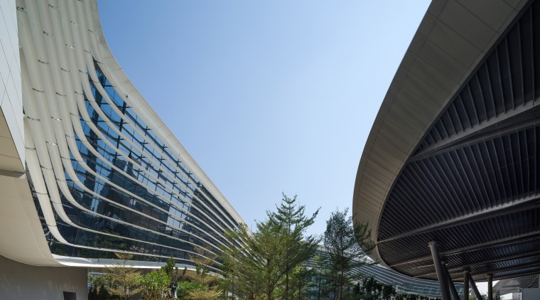 The sweeping, organic design of this ribbon of architecture, building, city, condominium, corporate headquarters, daylighting, daytime, facade, fixed link, headquarters, infrastructure, landmark, line, metropolis, metropolitan area, mixed use, sky, skyscraper, skyway, structure, urban area, black, teal