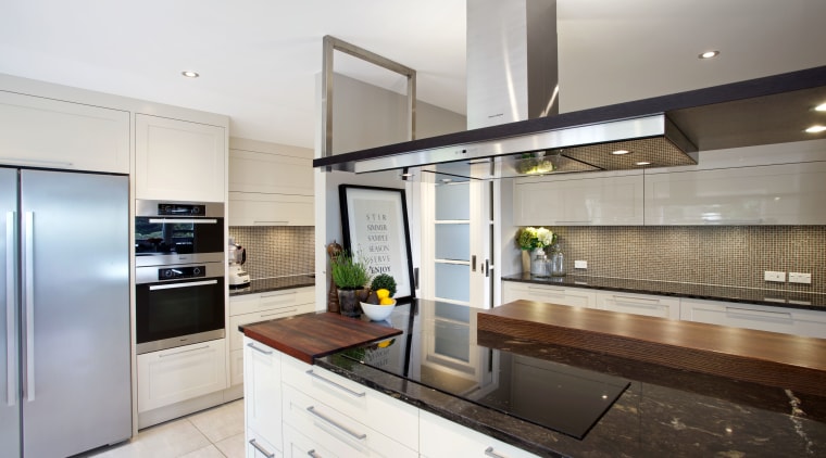 A removable wood prep board is integrated into countertop, cuisine classique, interior design, kitchen, real estate, white