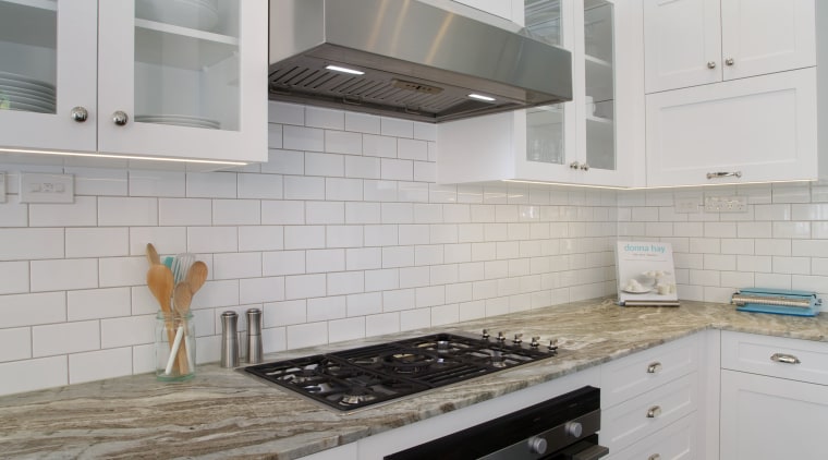 The ventilation unit in this kitchen was custom cabinetry, countertop, cuisine classique, floor, flooring, hardwood, home appliance, interior design, kitchen, kitchen appliance, kitchen stove, major appliance, room, tile, wood flooring, gray