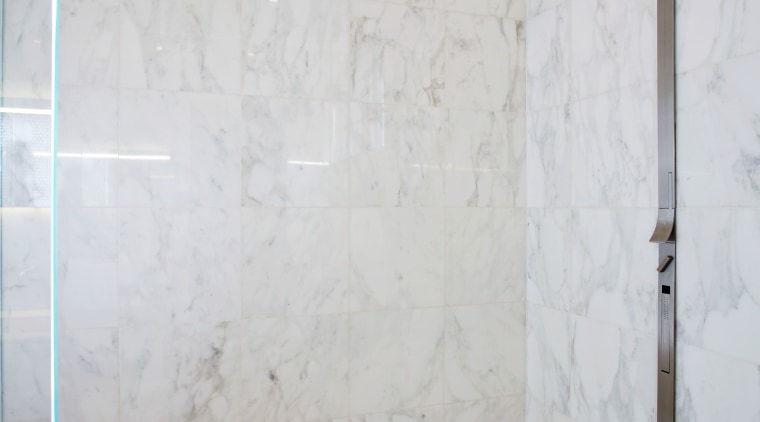 This shower stall has a Carrara marble lining bathroom, ceiling, floor, flooring, interior design, plaster, plumbing fixture, room, tile, wall, gray