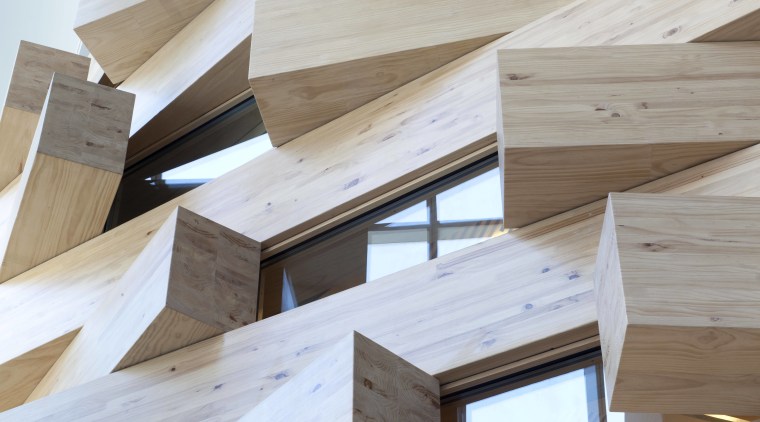 Interlocking timber blocks form an interior facade at angle, architecture, beam, daylighting, floor, hardwood, lumber, plywood, product design, wood, wood stain, gray, white