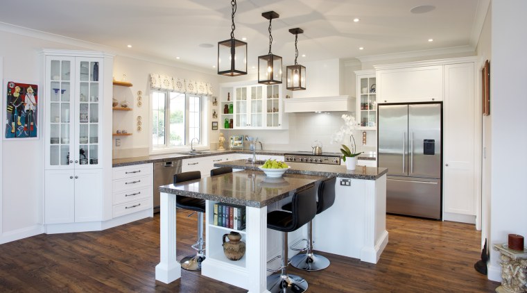 This high-end, traditional kitchen was produced by Mastercraft countertop, cuisine classique, floor, flooring, hardwood, interior design, kitchen, real estate, room, wood flooring, gray