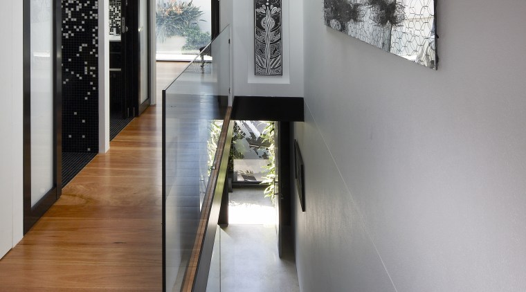 A skylight at the top of the stairs floor, flooring, hardwood, interior design, wood flooring, gray