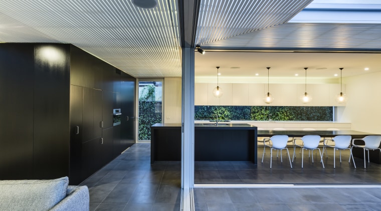 With large sliding glass doors wrapping around an architecture, ceiling, daylighting, house, interior design, lobby, real estate