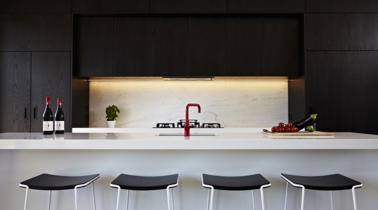 Architect Evelyn McNamara specified dark-stained American oak and countertop, furniture, interior design, kitchen, table, black, gray