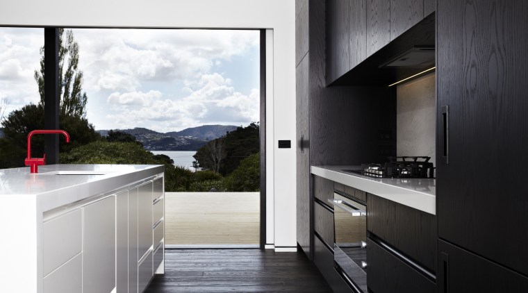 This kitchen, in a modern beach house designed architecture, countertop, home, home appliance, house, interior design, kitchen, real estate, black, white