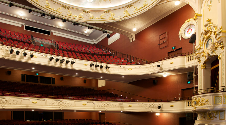 Custom chandeliers at the Isaac Theatre Royal were auditorium, ceiling, concert hall, opera house, performing arts center, theatre, orange, brown, red