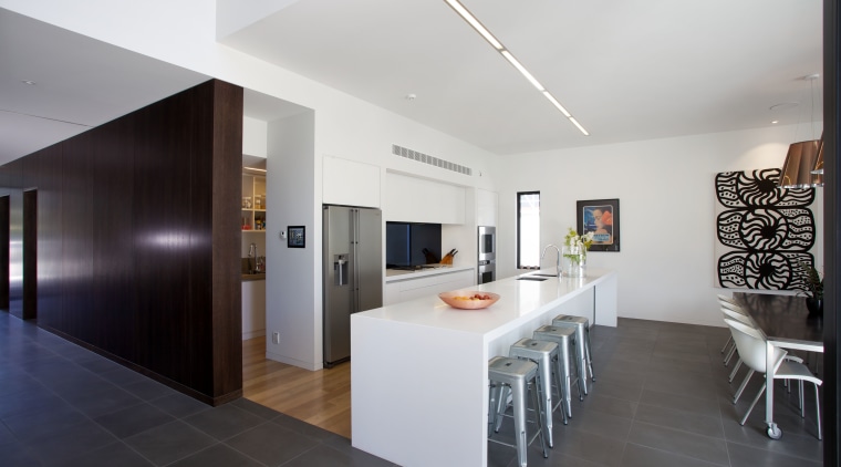 In this new house, a dark-stained timber wall architecture, ceiling, floor, house, interior design, kitchen, property, real estate, room, gray, black