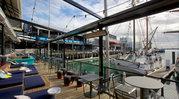 Terraced seating mitigates a drop in the level boat, deck, dock, marina, water, black, white