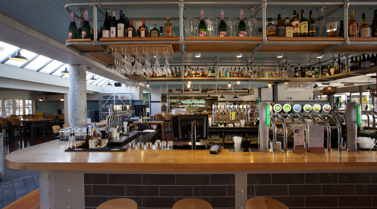 The bar occupies a central position in The liquor store, restaurant, black