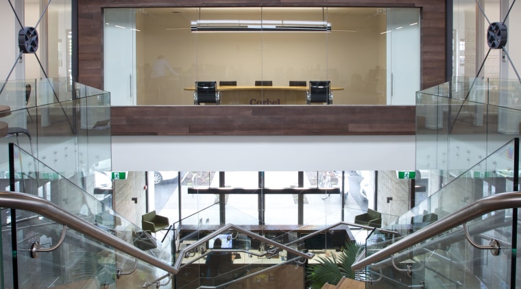 A twisting central staircase provides a dramatic centrepiece daylighting, floor, flooring, glass, interior design, wood, gray