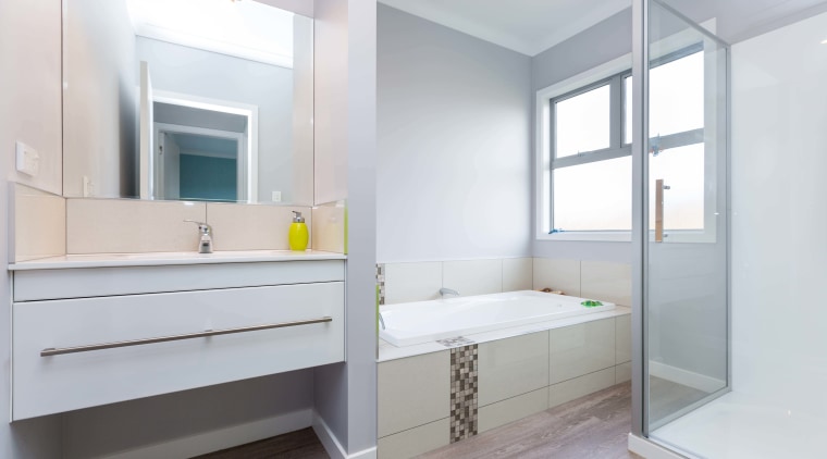 A band of grey-toned tiles wraps down the architecture, bathroom, floor, home, interior design, real estate, room, white, gray