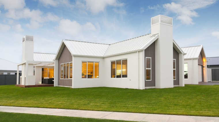 Contemporary pavilion-style home with gabled roofline and white-on-white architecture, cottage, elevation, estate, facade, farmhouse, home, house, property, real estate, residential area, white, brown