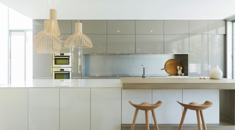 Sleek finishes, touches of wood, and recessed handles cabinetry, countertop, cuisine classique, interior design, kitchen, product design, white, gray