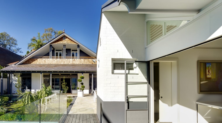 An upstairs bedroom is tucked into one of architecture, building, cottage, daylighting, elevation, estate, facade, home, house, property, real estate, residential area, roof, siding, villa, window, gray, white