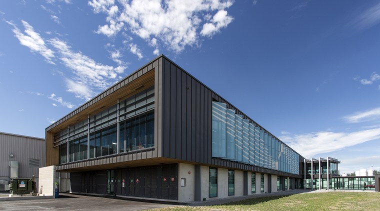 Wood soffits add a natural accent to the architecture, building, commercial building, corporate headquarters, facade, headquarters, mixed use, real estate, sky, teal