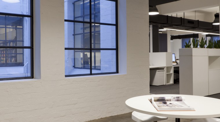 The original high ceilings and perimeter windows of architecture, floor, furniture, interior design, office, product design, table, gray, black