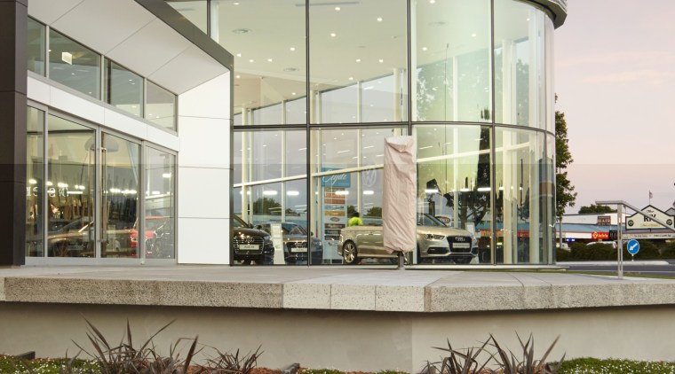 This dramatic curving showroom facade is created in architecture, building, home, house, mixed use, real estate, gray, brown