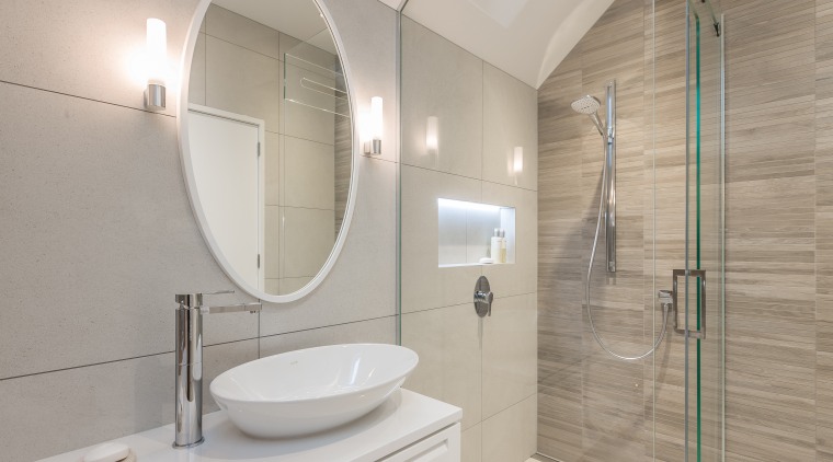 Planar surfaces are softened by the introduction of architecture, bathroom, floor, home, interior design, plumbing fixture, product design, property, room, tap, tile, gray