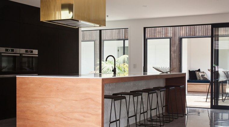 This kitchen achieves an abstract quality with all cabinetry, countertop, cuisine classique, floor, furniture, interior design, kitchen, gray