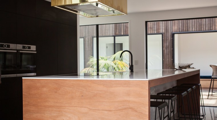 A matt black wall of perimeter cabinetry and architecture, cabinetry, chest of drawers, countertop, cuisine classique, furniture, interior design, kitchen, real estate, table, gray