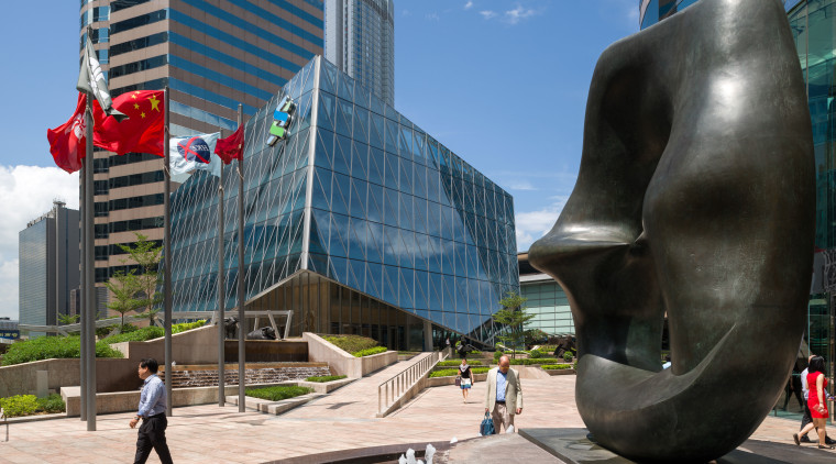 Buildings in a city hub can reflect the architecture, building, city, condominium, daytime, downtown, landmark, metropolis, metropolitan area, mixed use, monument, plaza, sculpture, skyscraper, statue, tourist attraction, black, gray