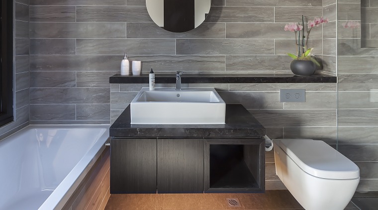 A feature circular mirror conceals storage and reinforces architecture, bathroom, countertop, floor, flooring, interior design, kitchen, product design, sink, tap, tile, gray