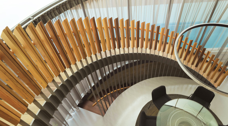 A spiral staircase looks down on the dining stairs, brown