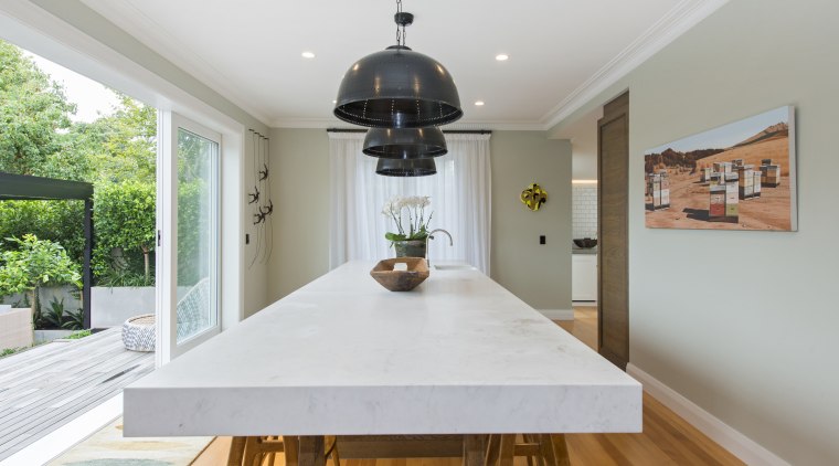 This countertop starts out in slender format at architecture, ceiling, daylighting, dining room, estate, floor, home, house, interior design, property, real estate, room, table, window, gray