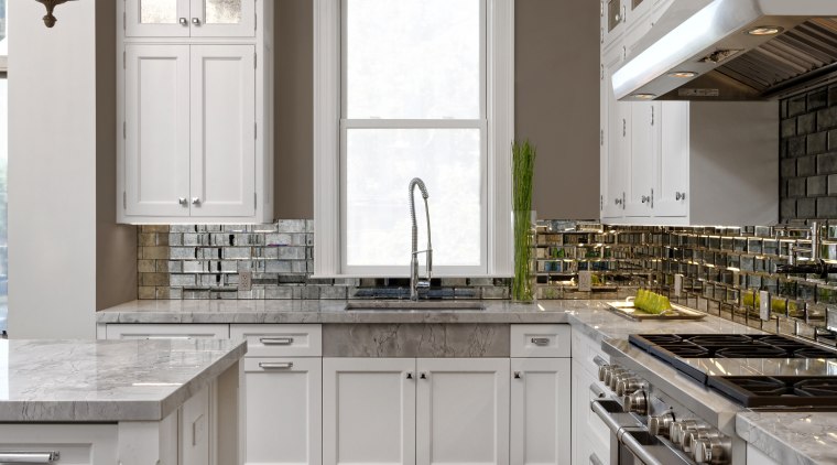 Wood floors and a taupe-coloured wall tone create cabinetry, countertop, cuisine classique, floor, flooring, hardwood, home, interior design, kitchen, room, wood flooring, gray, brown