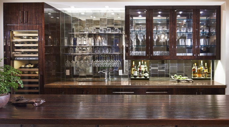 Mick De Giulio also designed this bar alongside bookcase, cabinetry, furniture, interior design, liquor store, lobby, shelving, red