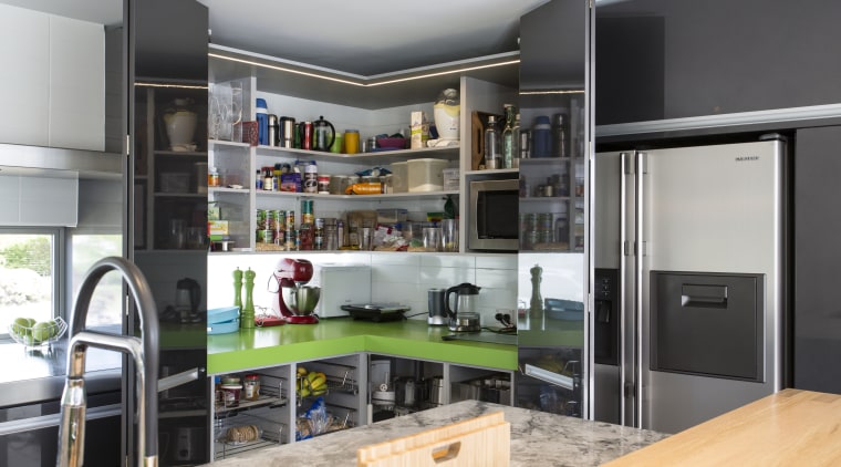 Kitchen designer Chris Moore introduced a generous corner countertop, interior design, kitchen, gray, black