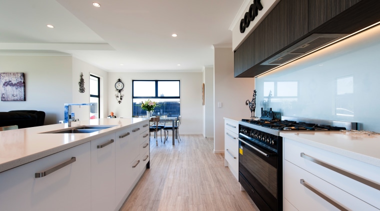 A substantial range and modern glass splashbacks make countertop, interior design, kitchen, real estate, room, gray