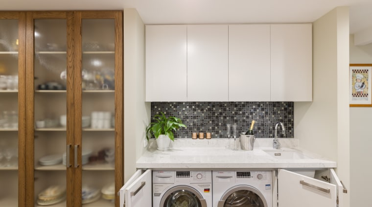 Blade walls were introduced to define the laundry cabinetry, countertop, cuisine classique, home appliance, kitchen, laundry, laundry room, major appliance, room, gray, brown