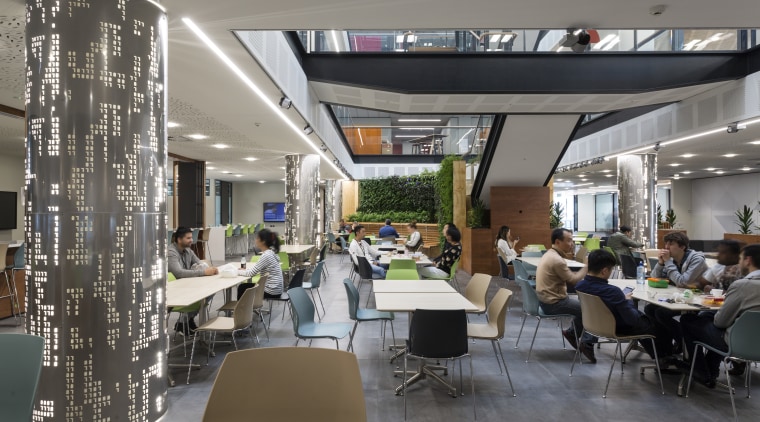 The soaring light-filled atrium of the Datacom building interior design, restaurant, gray