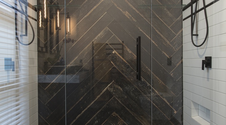 Contributing to this master suites dramatic black and bathroom, floor, flooring, glass, interior design, plumbing fixture, room, shower, tile, wall, gray, black