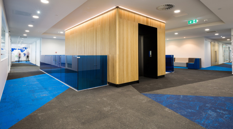 At the Sistema building, lift entries are finished floor, flooring, interior design, lobby, real estate, gray