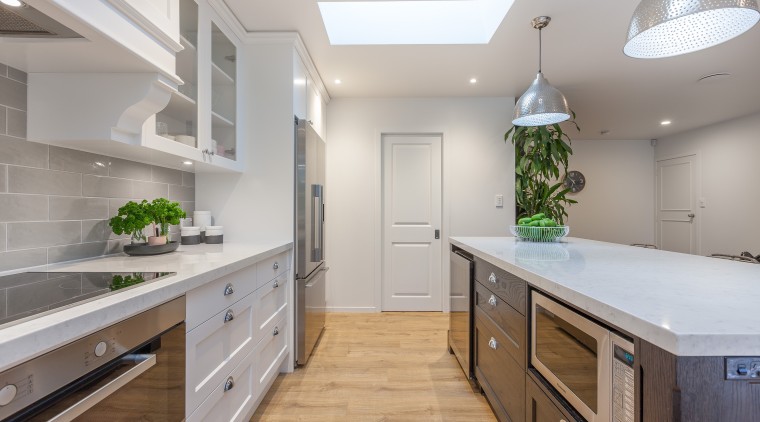 This kitchen renovation by designer Kira Gray offers cabinetry, countertop, home, interior design, kitchen, real estate, room, gray