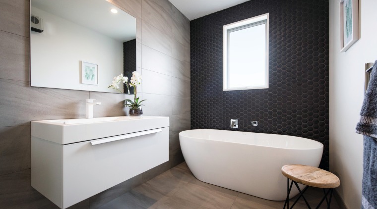 This contemporary GJ Gardner-designed bathroom includes a hexagon bathroom, floor, home, interior design, product design, room, sink, gray, black