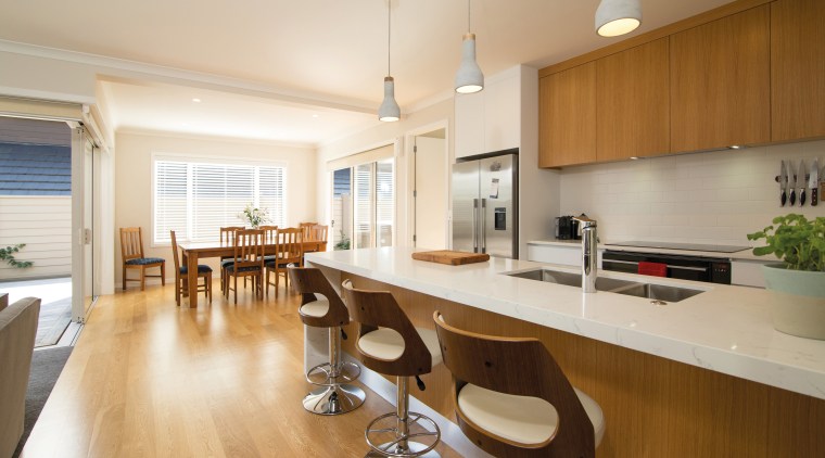 Featuring contemporary architectural lines, this home was built apartment, countertop, floor, flooring, hardwood, interior design, kitchen, property, real estate, room, wood flooring, white, brown