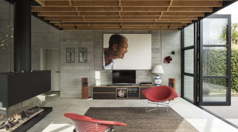 Board-faced concrete panels have been left exposed, providing architecture, house, interior design, living room, black, concrete,
