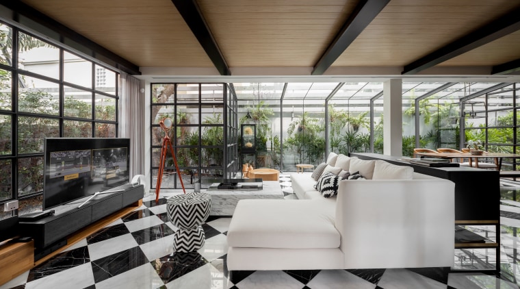An expansive downstairs living space was transformed beyond architecture, house, interior design, living room, furniture, furnishings, tile floor, glass extension, contemporary, renovation