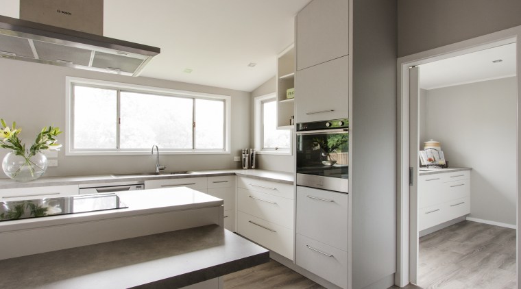This large scullery in a kitchen by Callidus cabinetry, countertop, cuisine classique, interior design, kitchen, real estate, gray