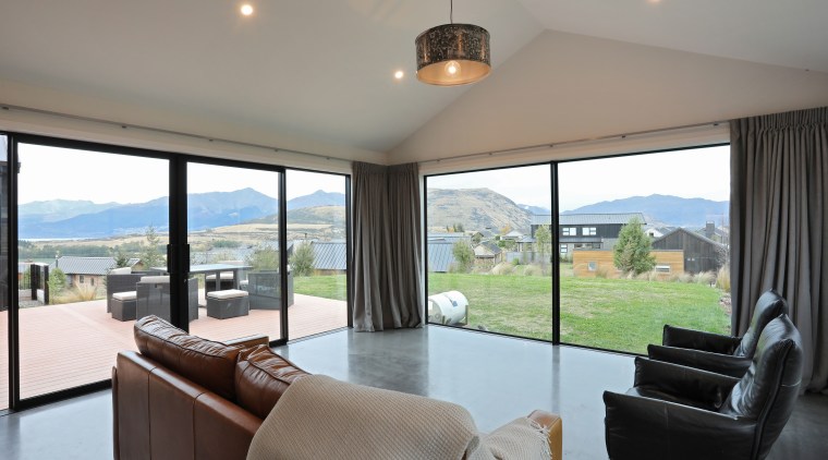 The open-plan living area on this Fowler Homes house, home, interior design, living room, windows, Fowler Homes southern lakes, polished concrete floors