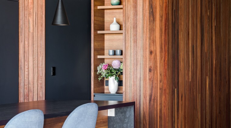 Vertical niche display shelving beside the entry to 